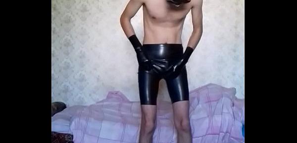  Guy putting on long latex shorts